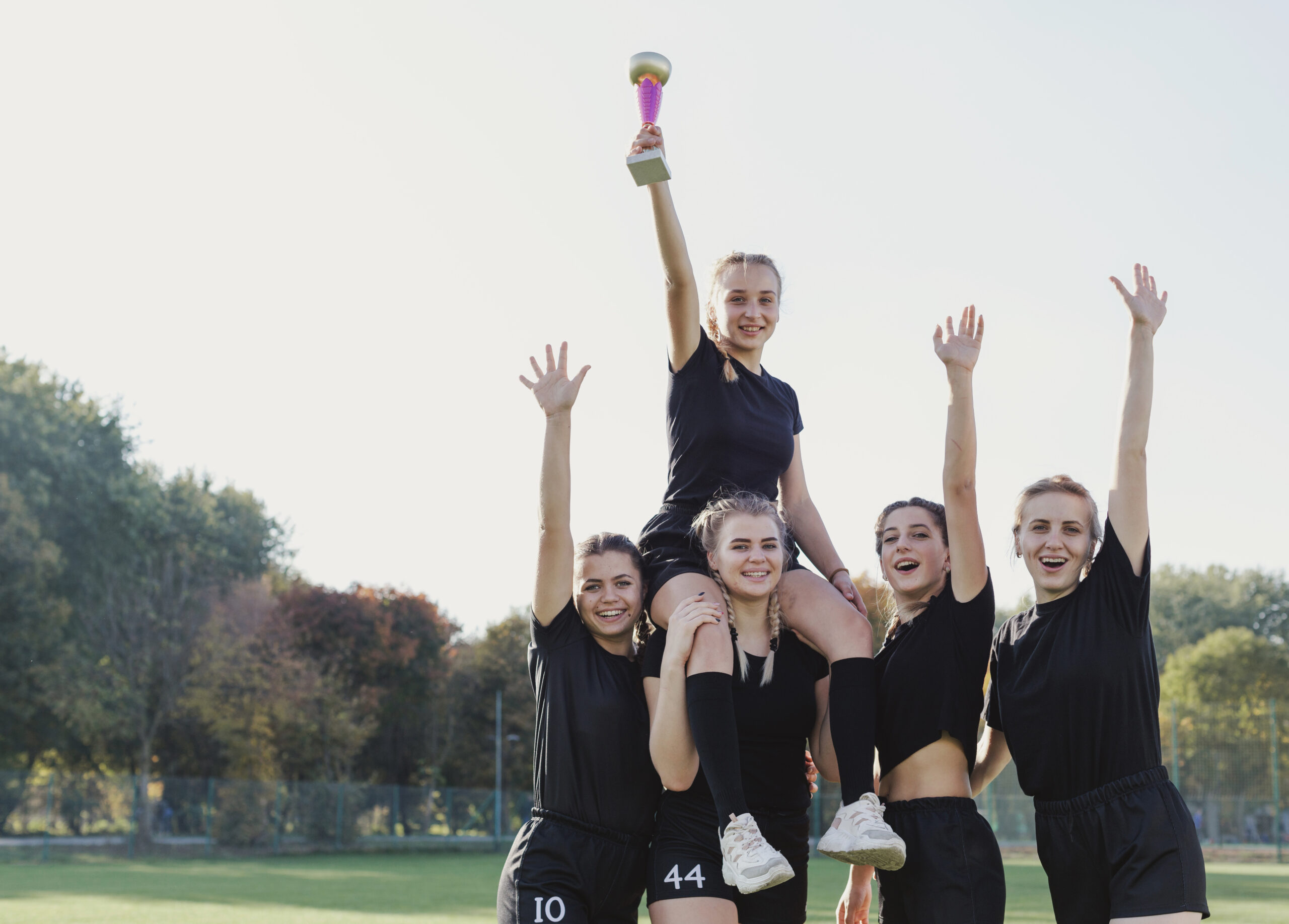 sportive-girls-winning-trophy