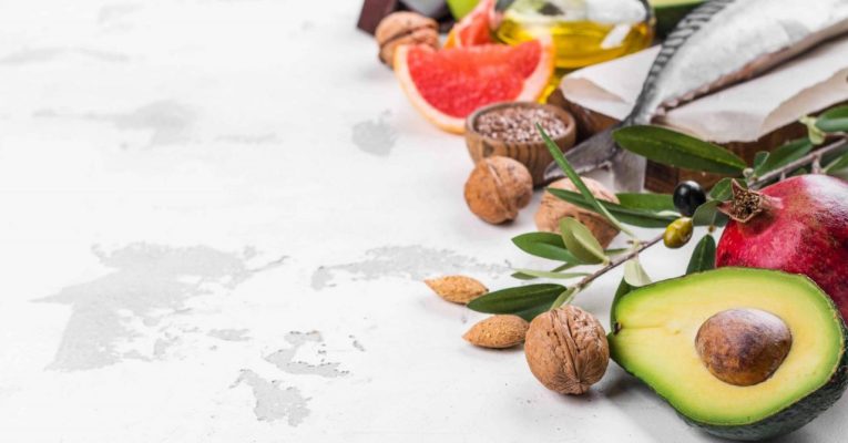 Selection of foods for healthy and strong heart and blood system on white stone background. Copy space